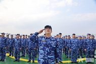 Vietnamese coast guard personnel hold flag-raising ceremony at sea